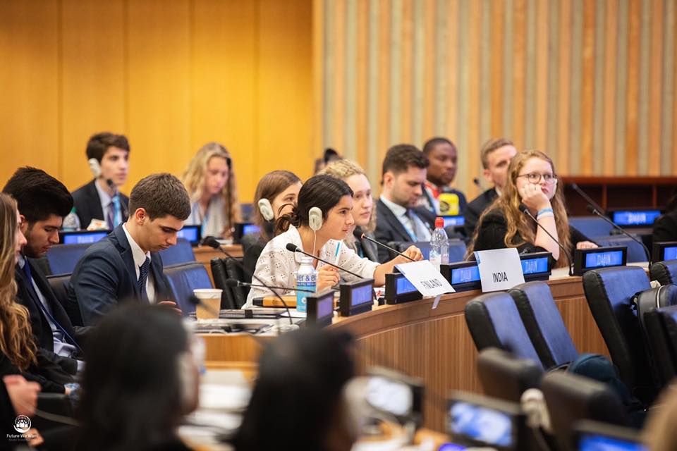 A delegate speaking on the microphone from the audience at the Future We Want MUN conference 2019.