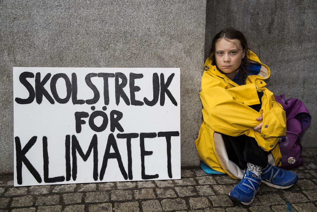 Photo of Greta Thunberg with a sign protesting climate change