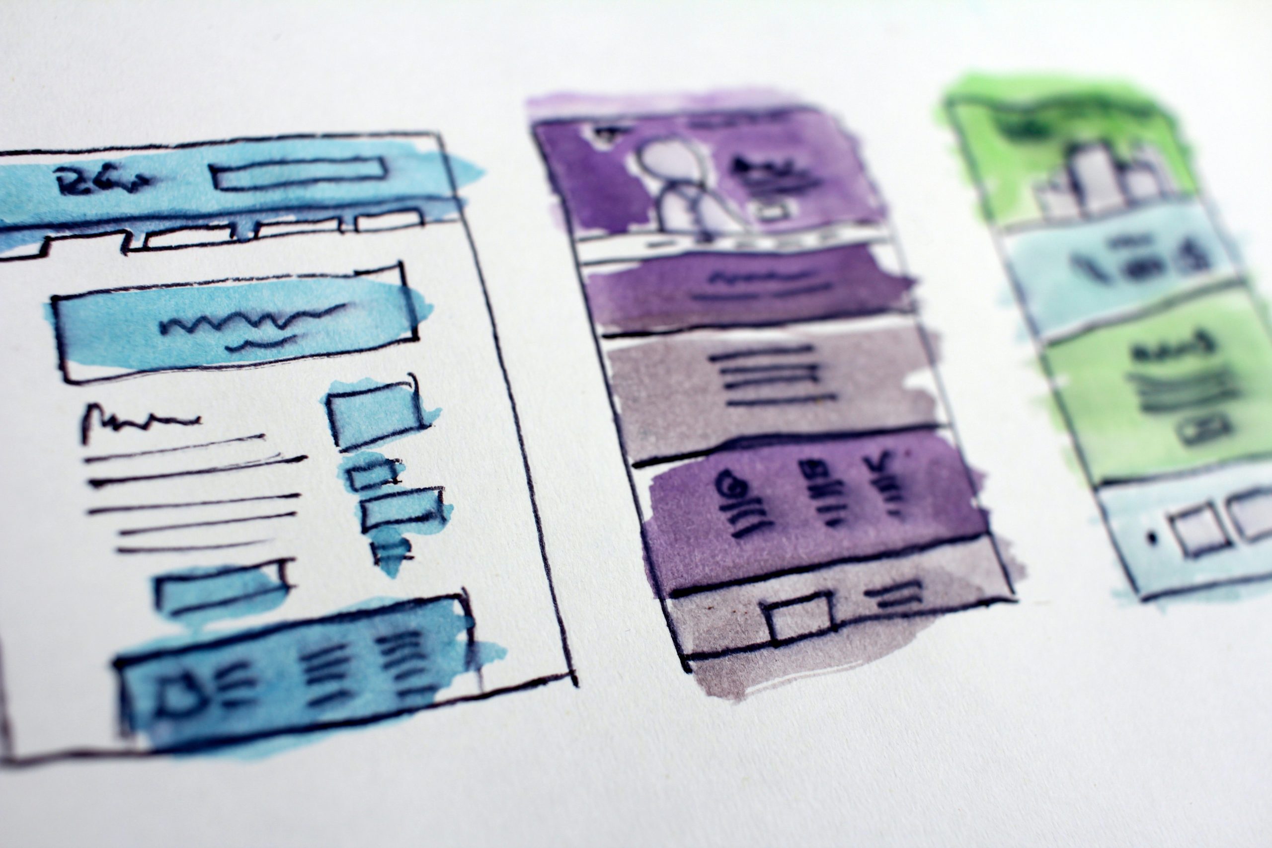 A purple and blue wireframe sketch of a website, drawn on paper