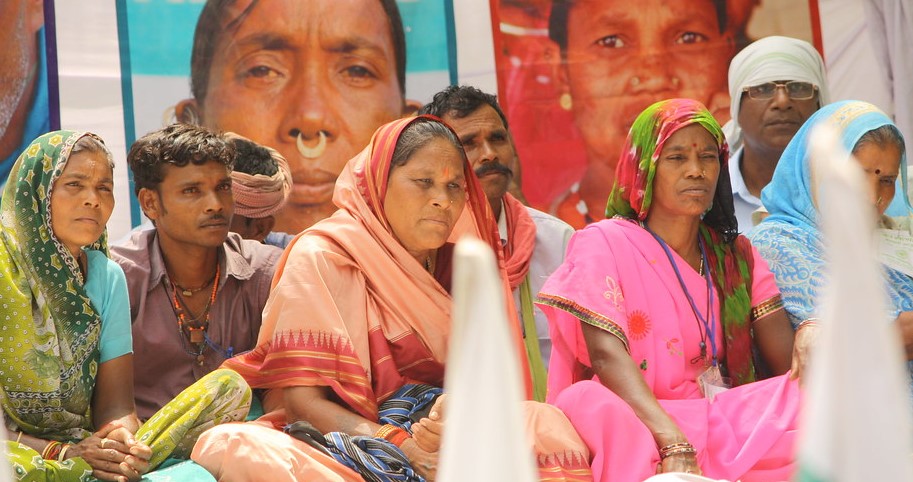 Dalit women sitting at a protest in India. 