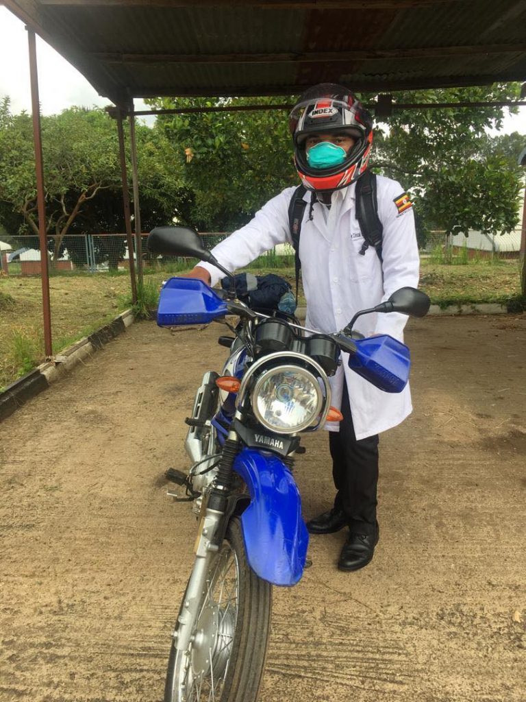 Image of Arafat standing next to his motocycle