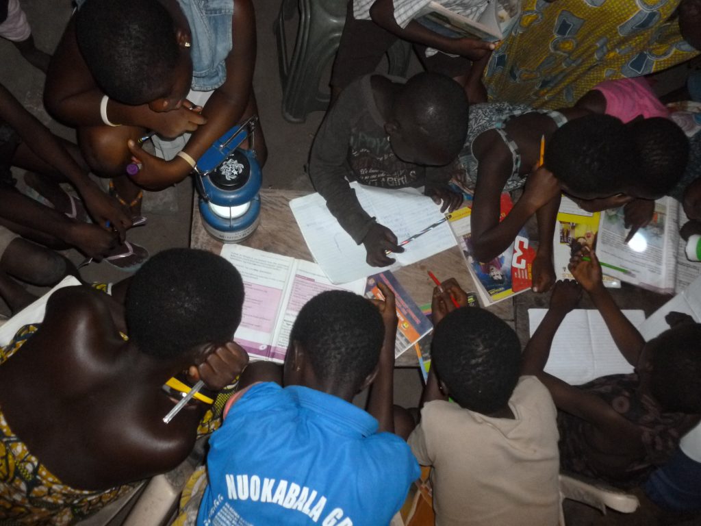 Pupils of Adaklu Dawanu, a rural  community in Ghana studying at night without electricity.