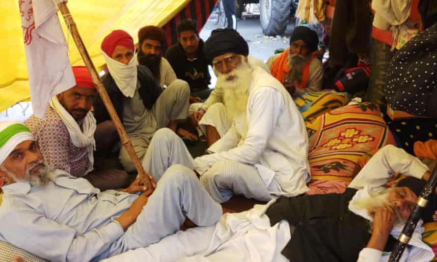 Elderly farmers in their cabin at the Delhi border