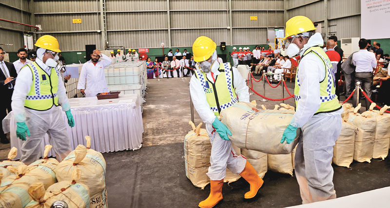 An image of Sri Lankan officials destroying a $108 Million haul of cocaine