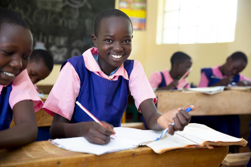 Image of young girls at school, learning happily!