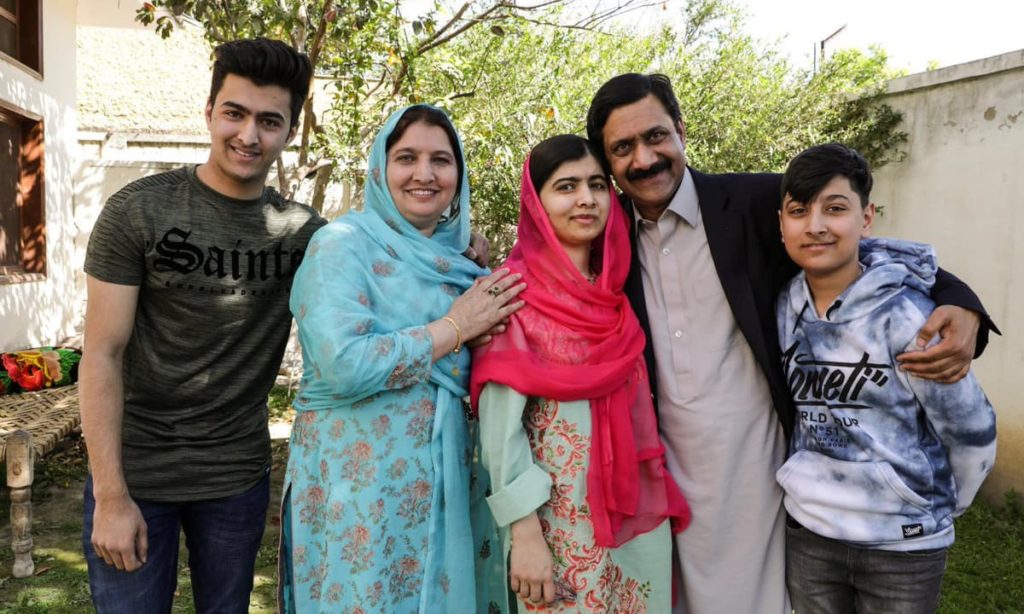 This image shows a picture of Malala Yousafzai's family with her parents and younger brothers. 