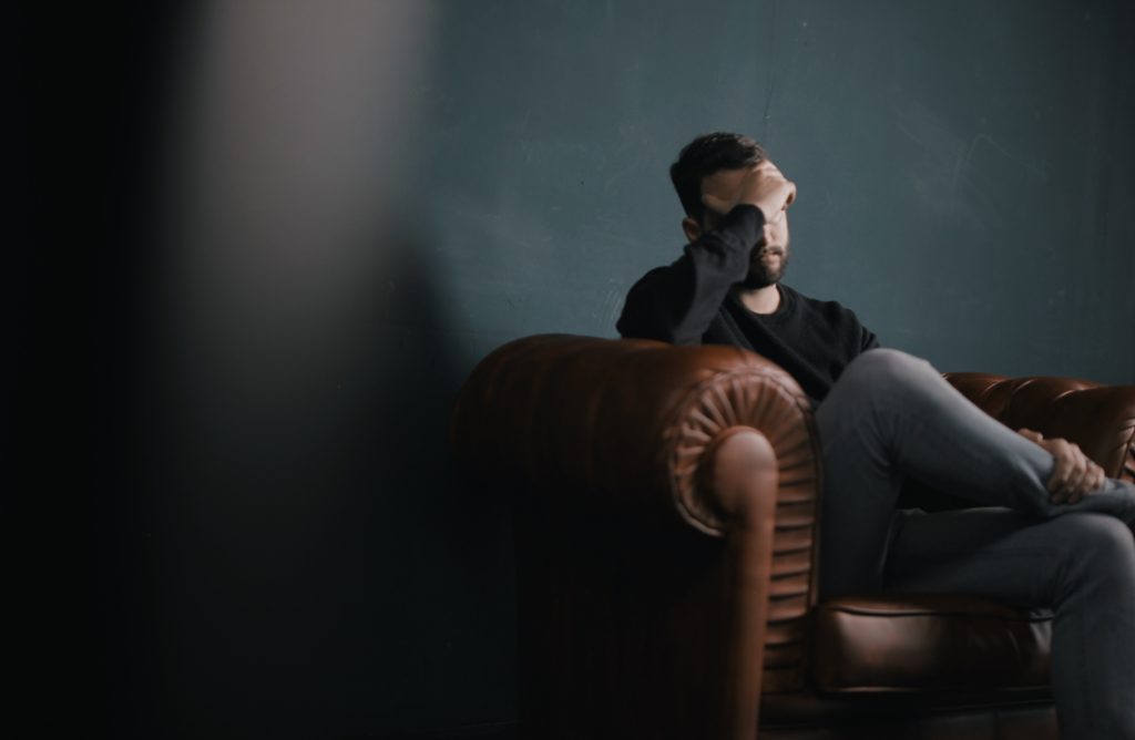 Image of an upset man, included to offer context to the subject matter of mental healthcare.