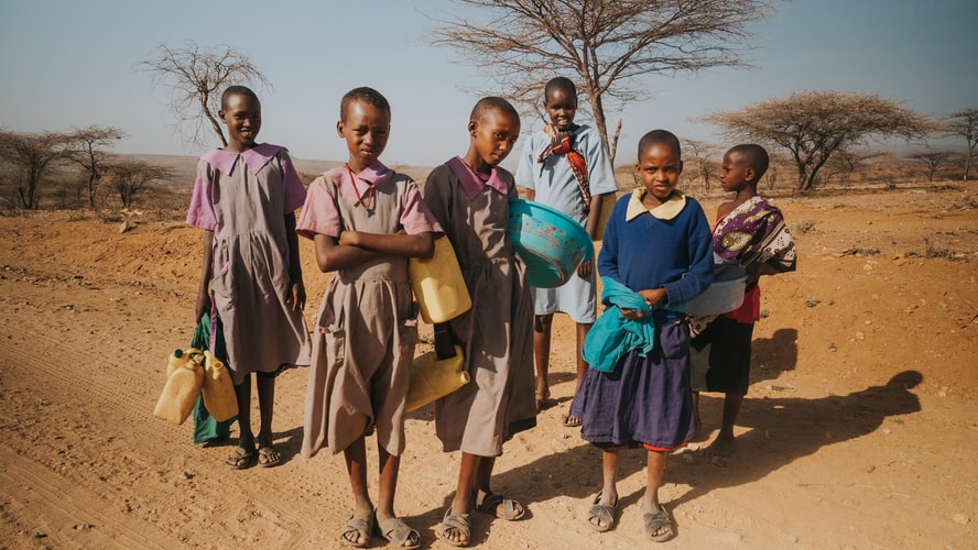 Local children fetching water and other supplies.