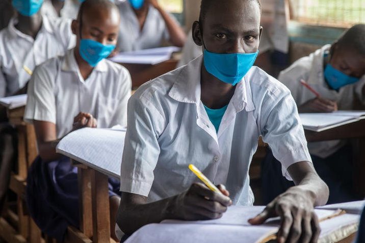 An image of a refugee child studying