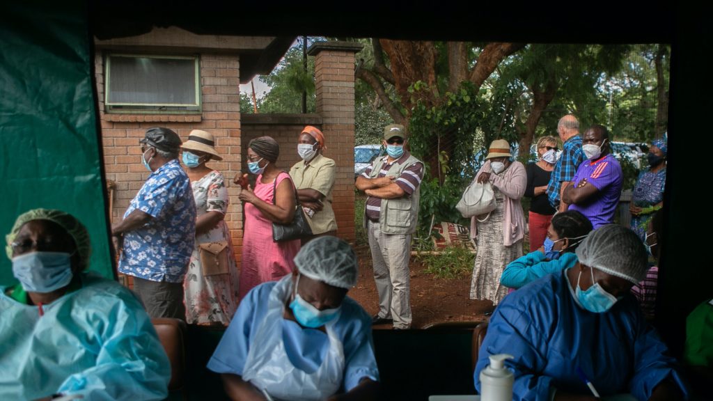 Image of people queueing for a Covid-19 vaccine shot