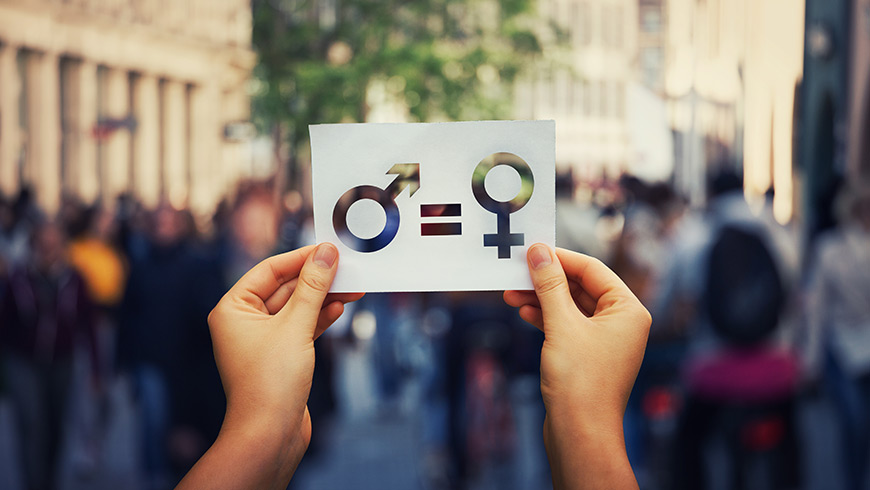 A person holding a gender equality sign