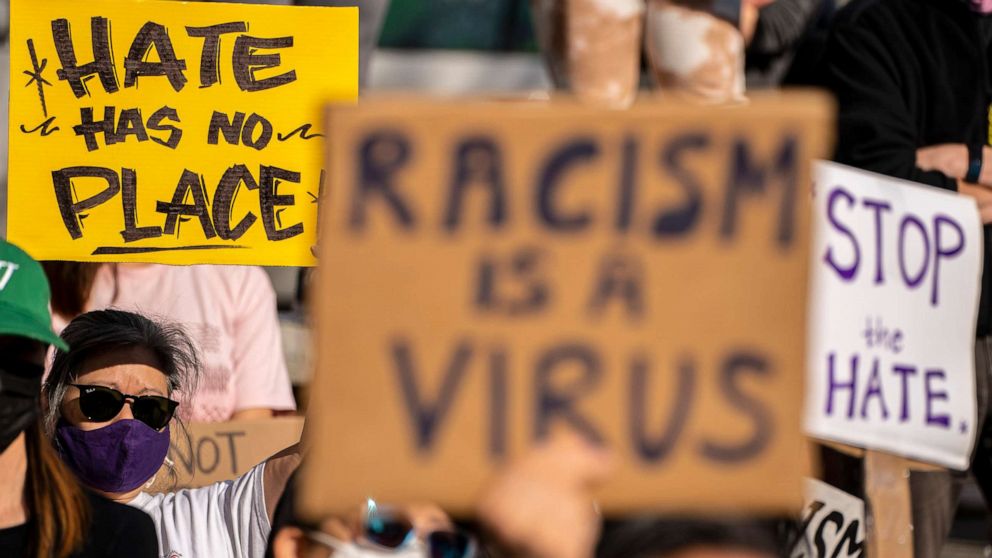 Image of protesters holding anti-racism placards