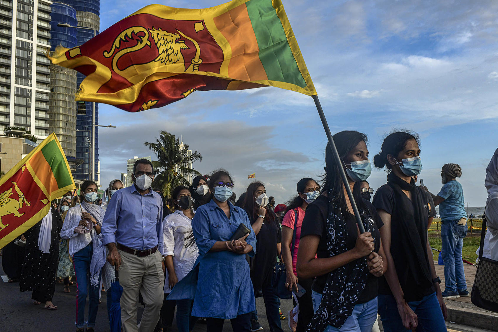 Protesters carrying the Sri Lanka flag march in the Galle Face Green area of Colombo, Sri Lanka, May 17, 2022.