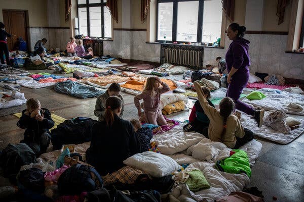 a group of girls and women in a refugee camp